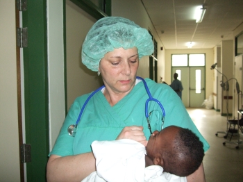 Dr. Stoller consoles an infant prior to his hernia surgery