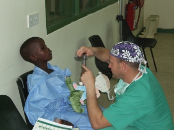 Dr. Drew Schnitt examines one of his patients prior to surgery to repair a cleft lip and palate